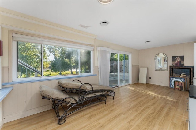 living area featuring a wealth of natural light and light hardwood / wood-style flooring