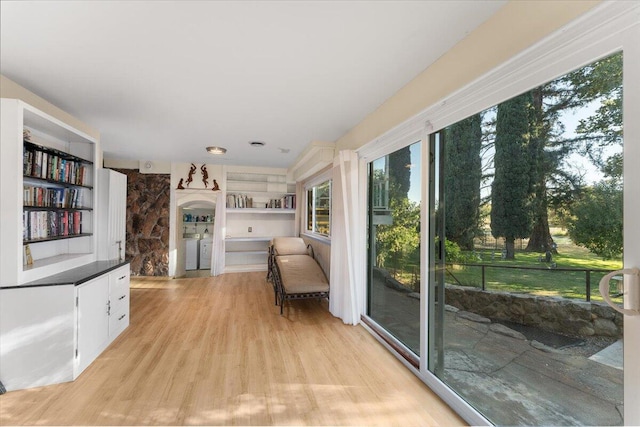 interior space featuring washing machine and dryer and light hardwood / wood-style floors