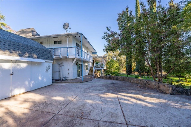 back of property featuring a patio and a balcony