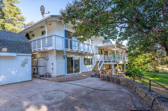 back of property with a patio area and a balcony