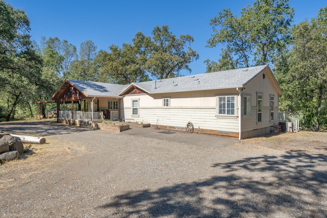 view of front of property featuring cooling unit and covered porch