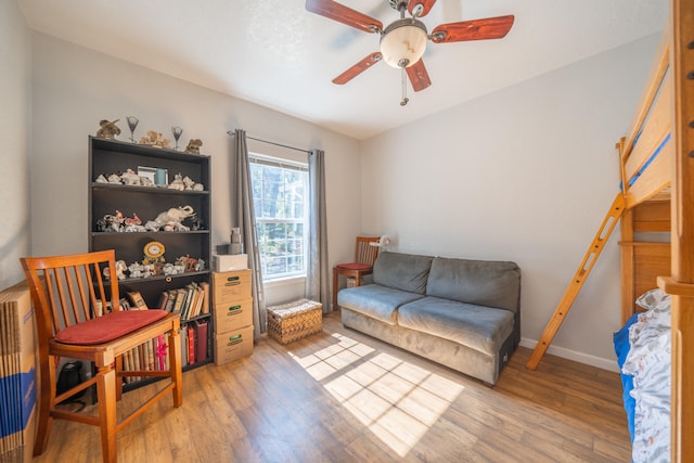 sitting room featuring hardwood / wood-style floors and ceiling fan