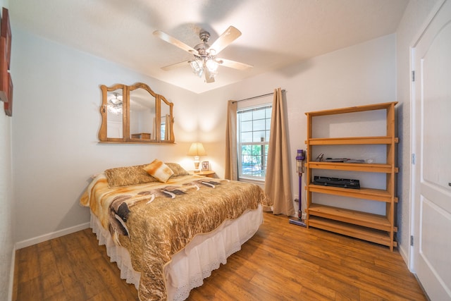 bedroom with ceiling fan and dark hardwood / wood-style flooring