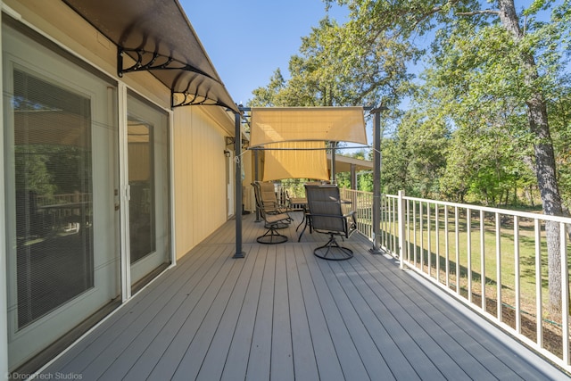 wooden deck with a lawn