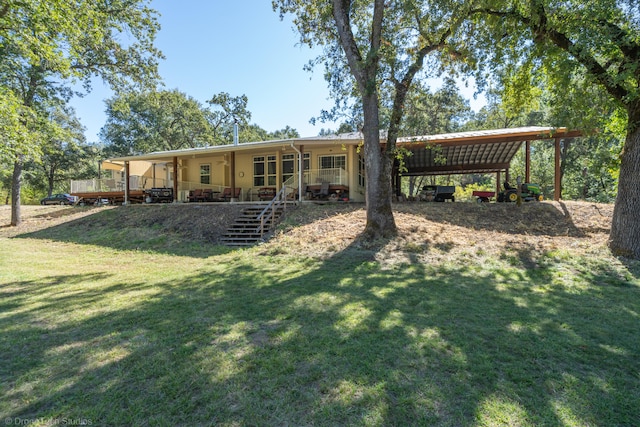 rear view of property featuring a lawn