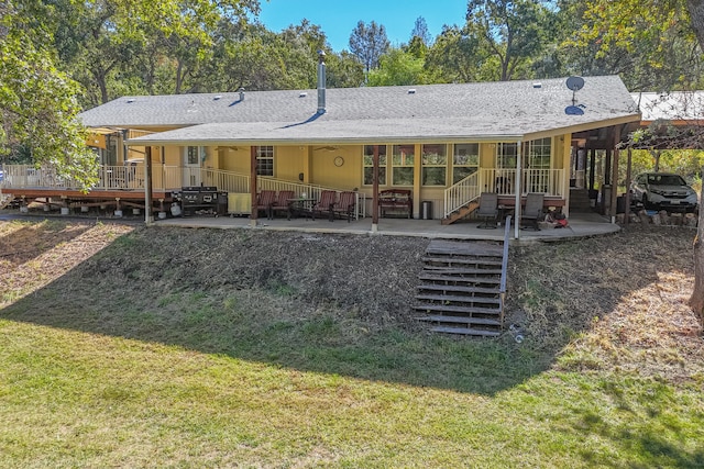 back of property featuring a yard and a patio