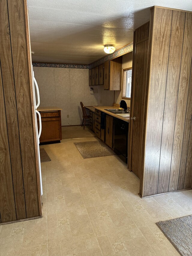 kitchen featuring dishwasher, fridge, and sink