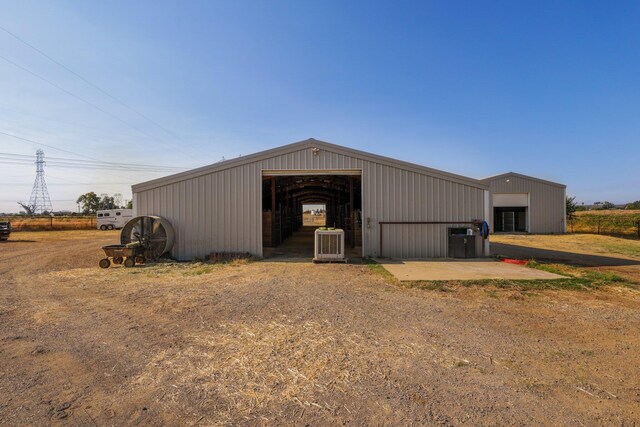 view of outdoor structure featuring cooling unit and a garage