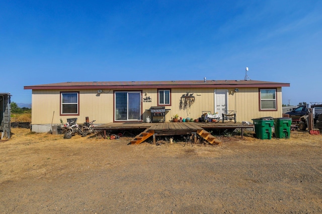 back of property featuring a deck