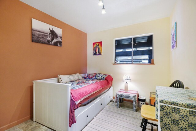 bedroom featuring track lighting