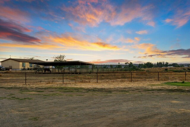 yard at dusk with a rural view