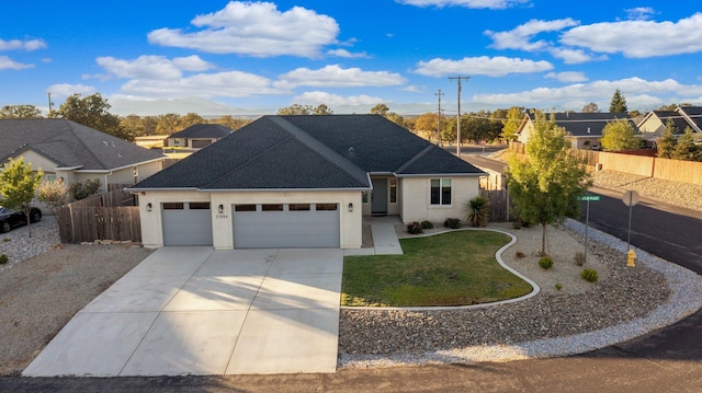 view of front of property with a front yard and a garage