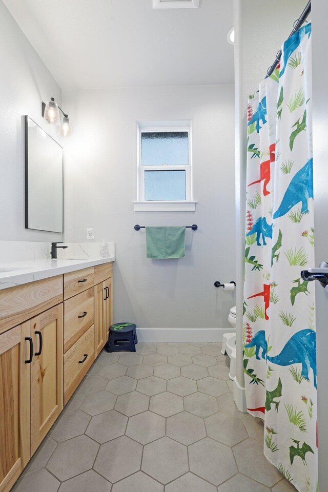 bathroom with a bidet, vanity, a shower with shower curtain, tile patterned flooring, and toilet