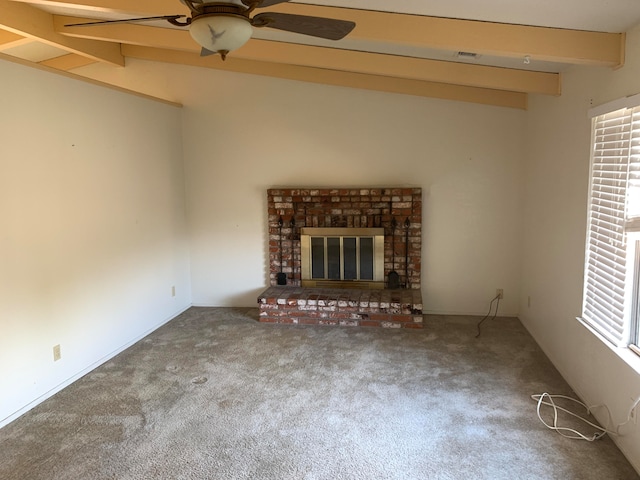 unfurnished living room featuring a fireplace, carpet floors, lofted ceiling with beams, and ceiling fan