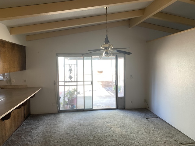 unfurnished dining area featuring vaulted ceiling with beams, ceiling fan, and carpet flooring