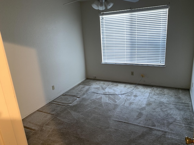 carpeted empty room featuring ceiling fan