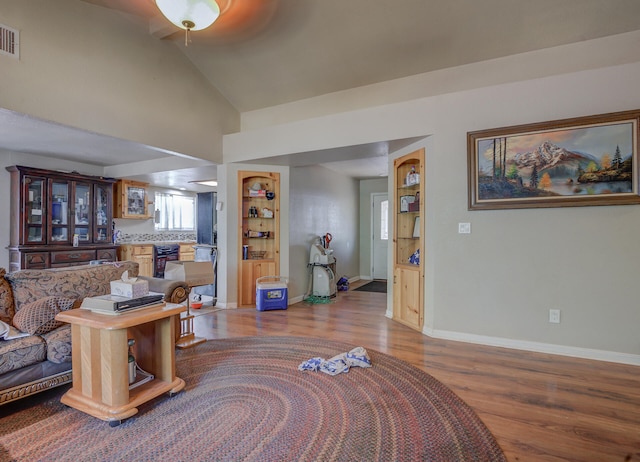 living room featuring lofted ceiling, ceiling fan, and hardwood / wood-style flooring