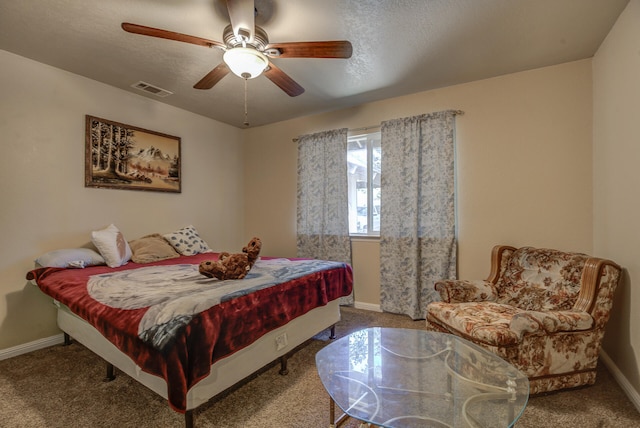 bedroom featuring a textured ceiling, ceiling fan, and carpet flooring