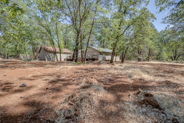 view of yard with a wooden deck