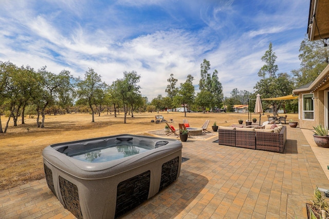 view of patio featuring a hot tub and an outdoor hangout area