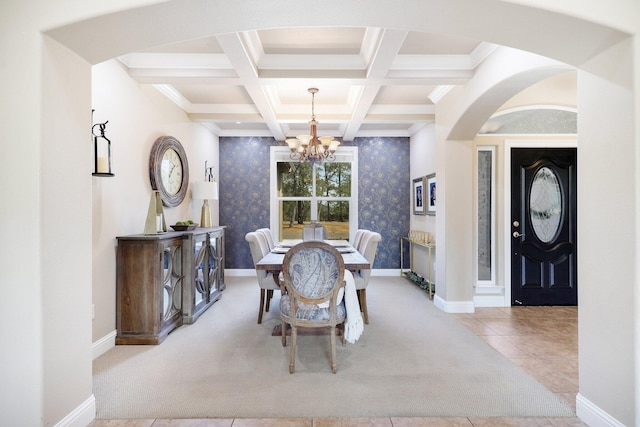 dining area featuring beam ceiling, a chandelier, coffered ceiling, and light tile patterned floors