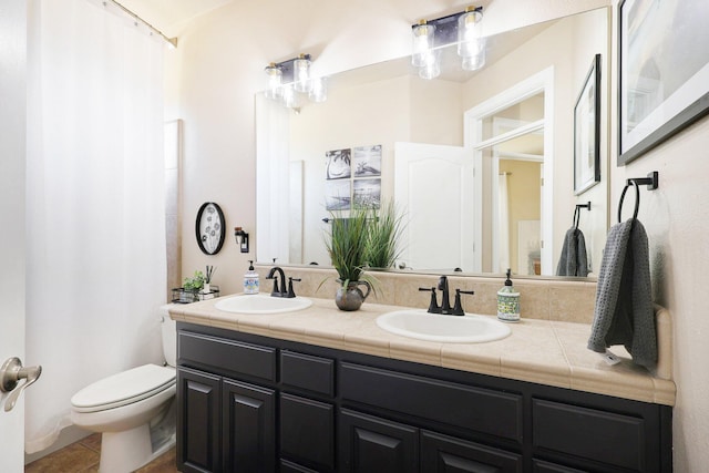 bathroom featuring vanity, toilet, and tile patterned floors