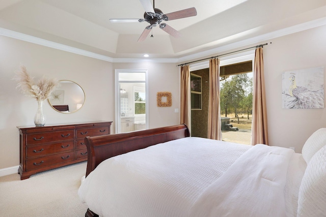 carpeted bedroom featuring ensuite bathroom, a tray ceiling, access to exterior, ceiling fan, and ornamental molding