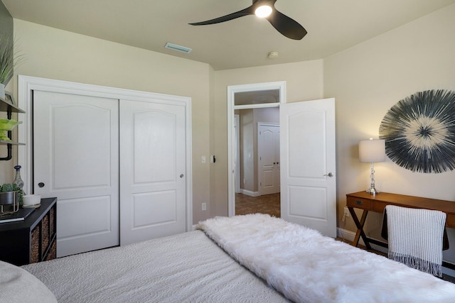 bedroom featuring light carpet, a closet, and ceiling fan