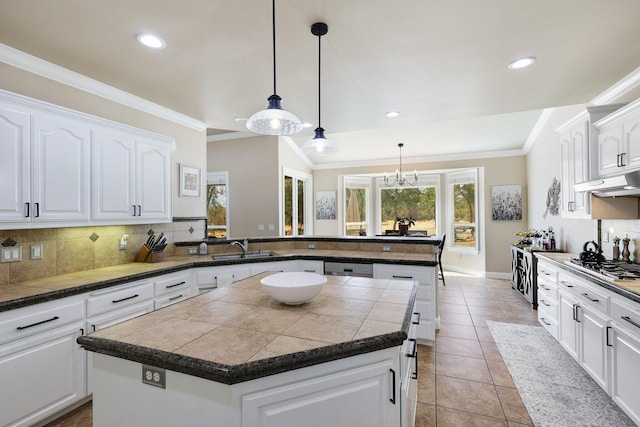 kitchen with a center island, kitchen peninsula, and white cabinets