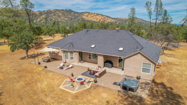 back of house with a patio and a mountain view