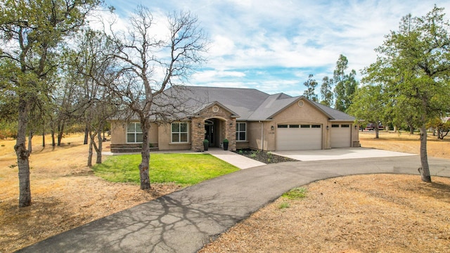 ranch-style home with a front yard and a garage