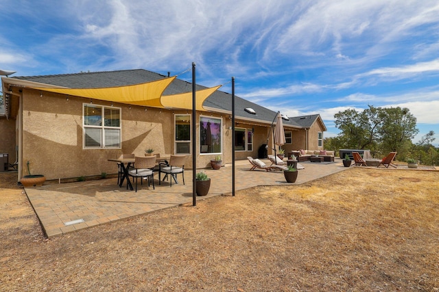 rear view of house featuring a patio and an outdoor hangout area