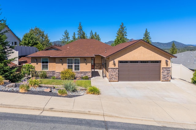 single story home with a mountain view and a garage