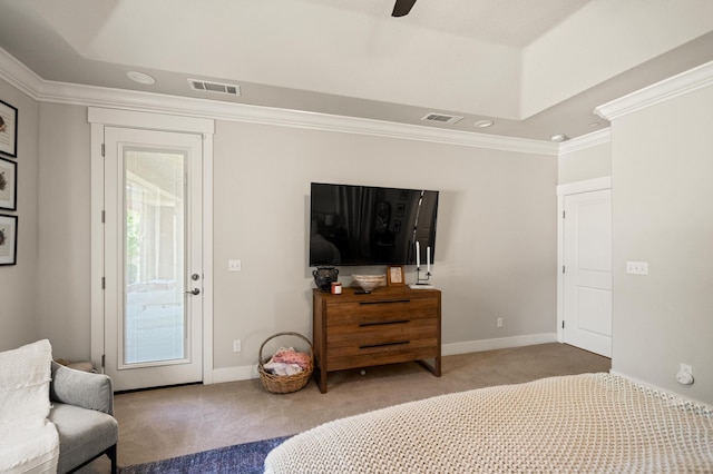 carpeted bedroom with crown molding, a tray ceiling, and ceiling fan