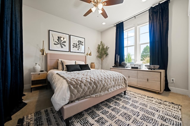 bedroom with light colored carpet and ceiling fan