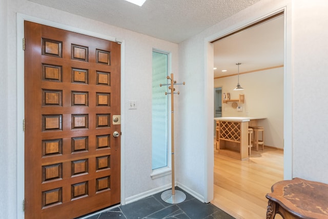 entrance foyer featuring dark hardwood / wood-style flooring and a textured ceiling