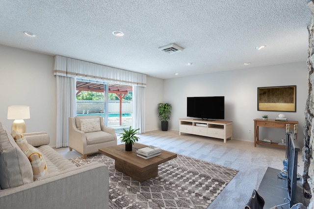 living room with a textured ceiling and carpet floors