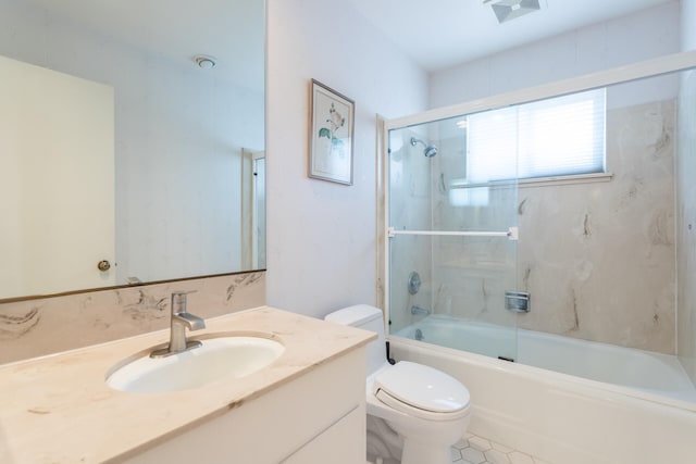 full bathroom featuring shower / bath combination with glass door, vanity, toilet, and tile patterned flooring