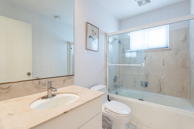 bathroom featuring combined bath / shower with glass door, visible vents, toilet, and vanity