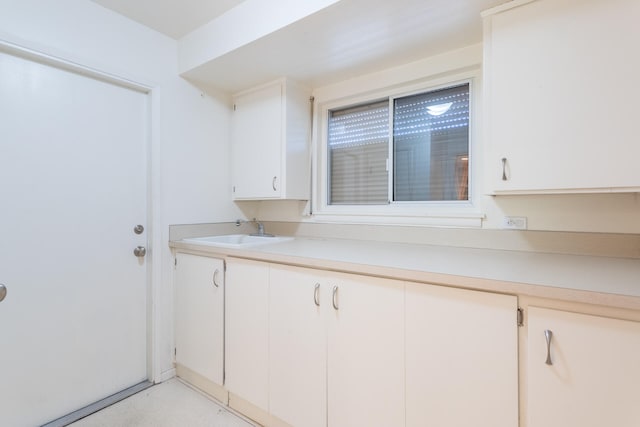 kitchen featuring sink and white cabinets