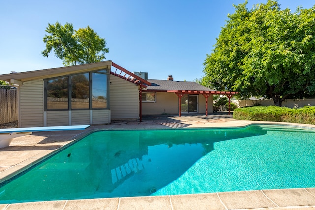 view of pool featuring a patio area and a diving board