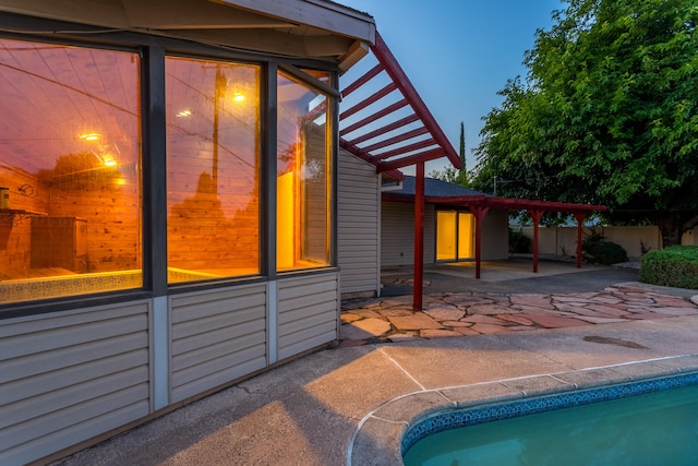 pool at dusk featuring a patio area