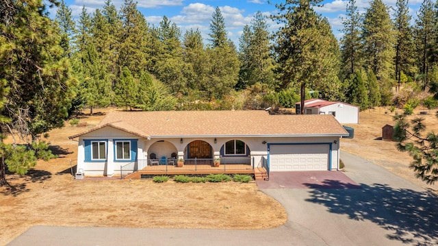 view of front of home featuring a garage and a porch