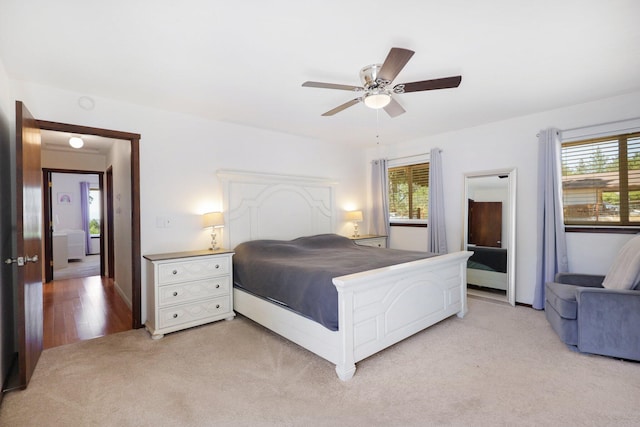 bedroom with ceiling fan and light colored carpet