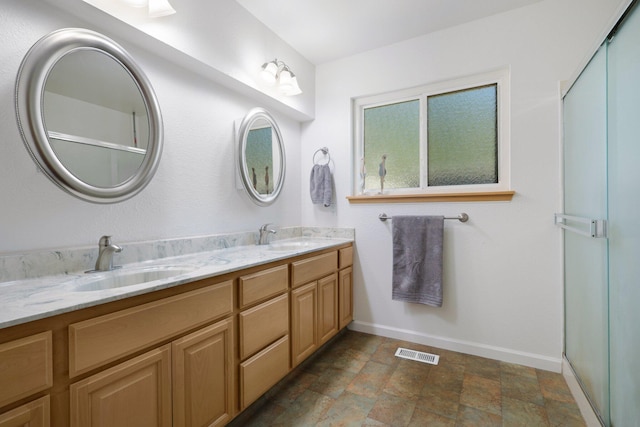 bathroom featuring vanity and an enclosed shower