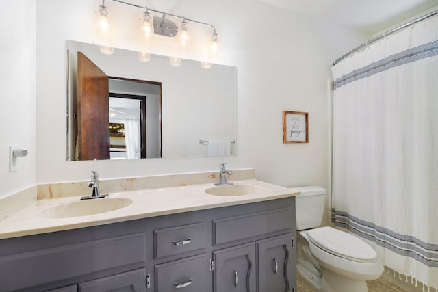 bathroom featuring tile patterned flooring, vanity, toilet, and curtained shower