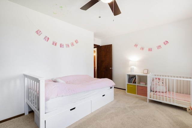 bedroom featuring light colored carpet and ceiling fan