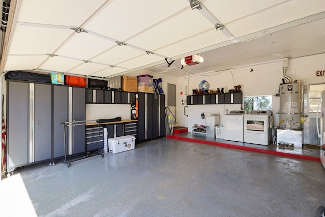 garage with washer and dryer, a garage door opener, and strapped water heater