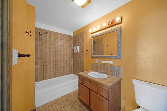 full bathroom with vanity, tile patterned floors, tiled shower / bath, and toilet