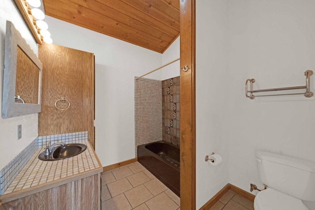 full bathroom with vaulted ceiling, vanity, tiled shower / bath combo, tile patterned flooring, and toilet